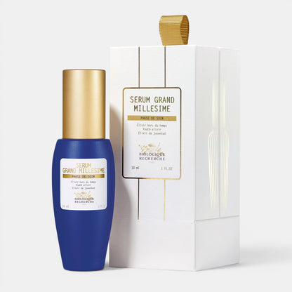 Shop Rescue Spa Serum Grand Millesime youth-enhancing face serum in a blue bottle next to its white gift box.