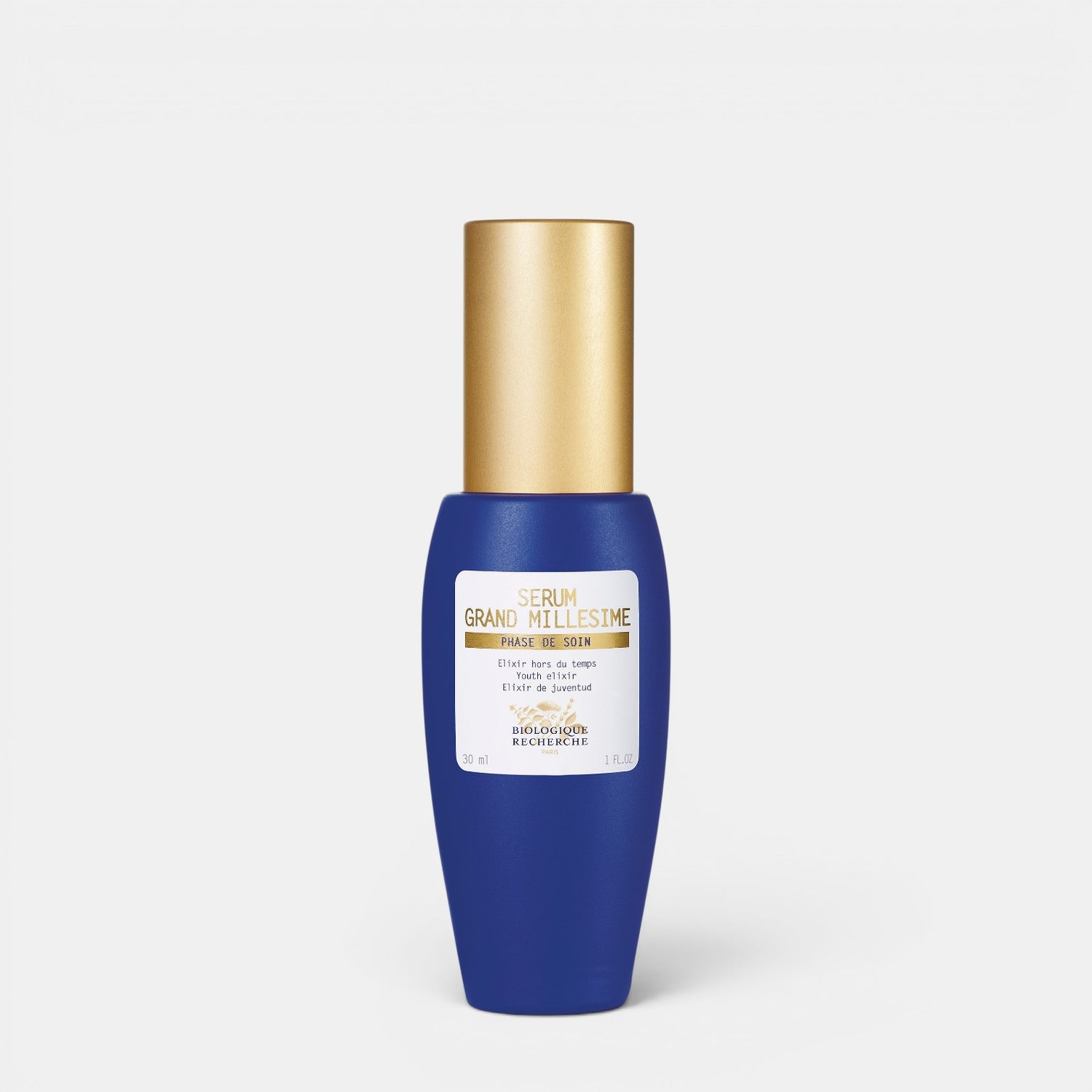 Shop Rescue Spa Serum Grand Millesime youth-enhancing face serum in a blue glass bottle with a gold cap.