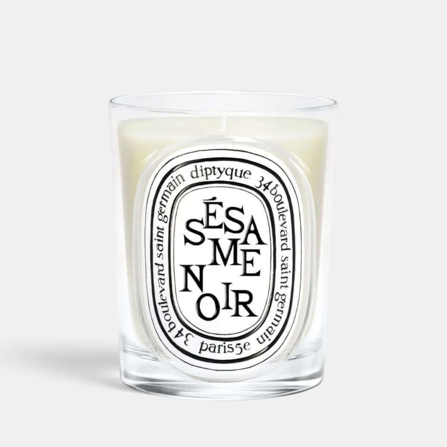 Shop Rescue Spa Sesame Noir scented candle in a clear glass vessel with a signature oval label