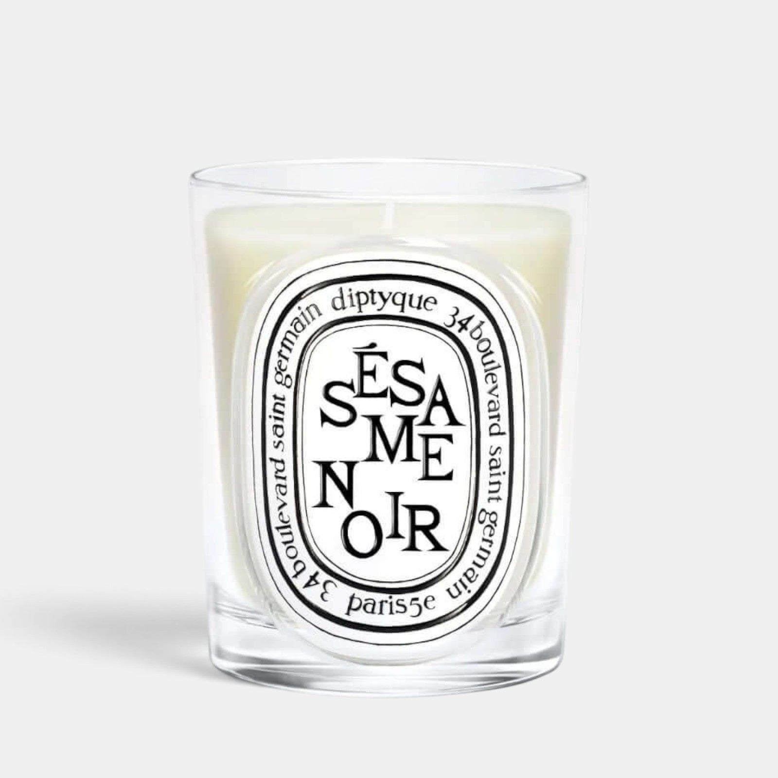 Shop Rescue Spa Sesame Noir scented candle in a clear glass vessel with a signature oval label