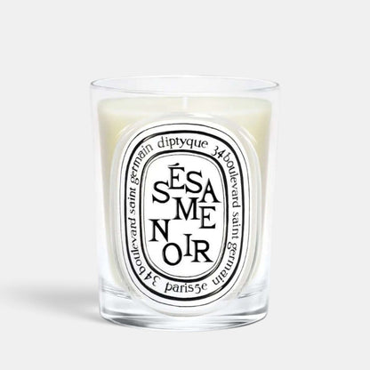 Shop Rescue Spa Sesame Noir scented candle in a clear glass vessel with a signature oval label