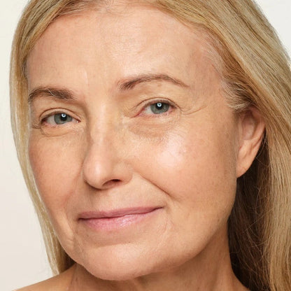 Shop Rescue Spa Sheer Glow Rose Face Tint applied on a mature woman&