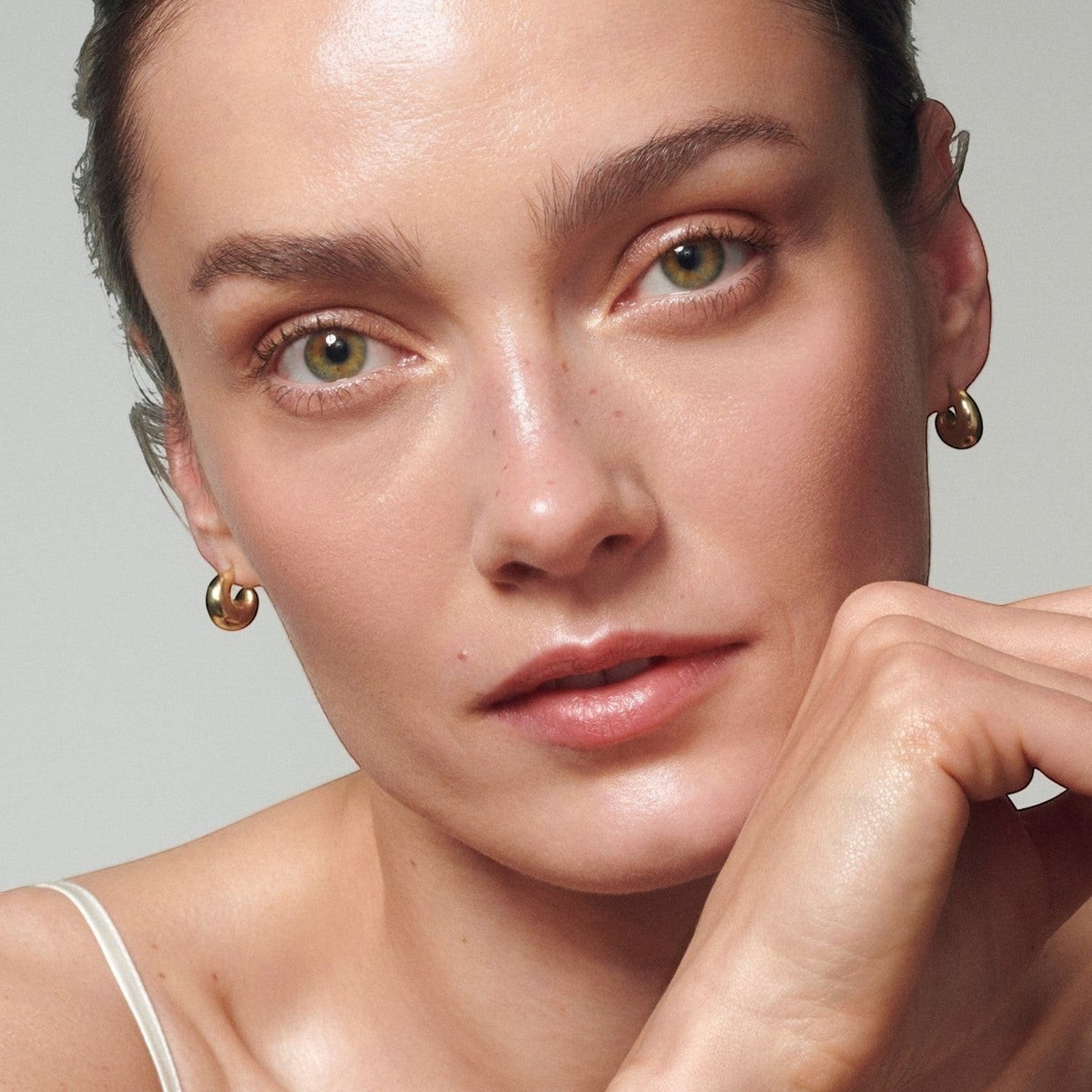 Model with radiant, hydrated skin showcasing the Shop Rescue Spa Skin Activator Serum results.