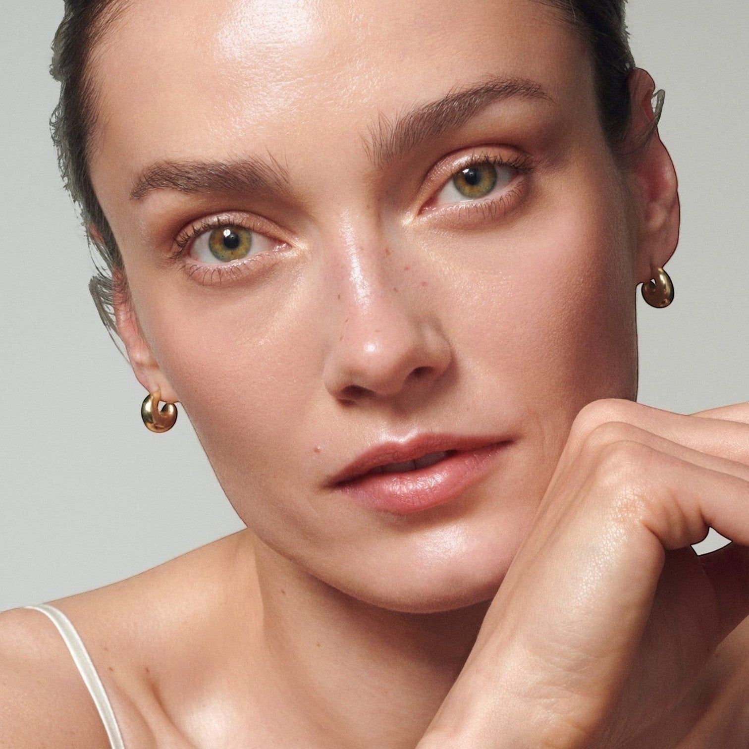 Model with radiant, hydrated skin showcasing the Shop Rescue Spa Skin Activator Serum results.