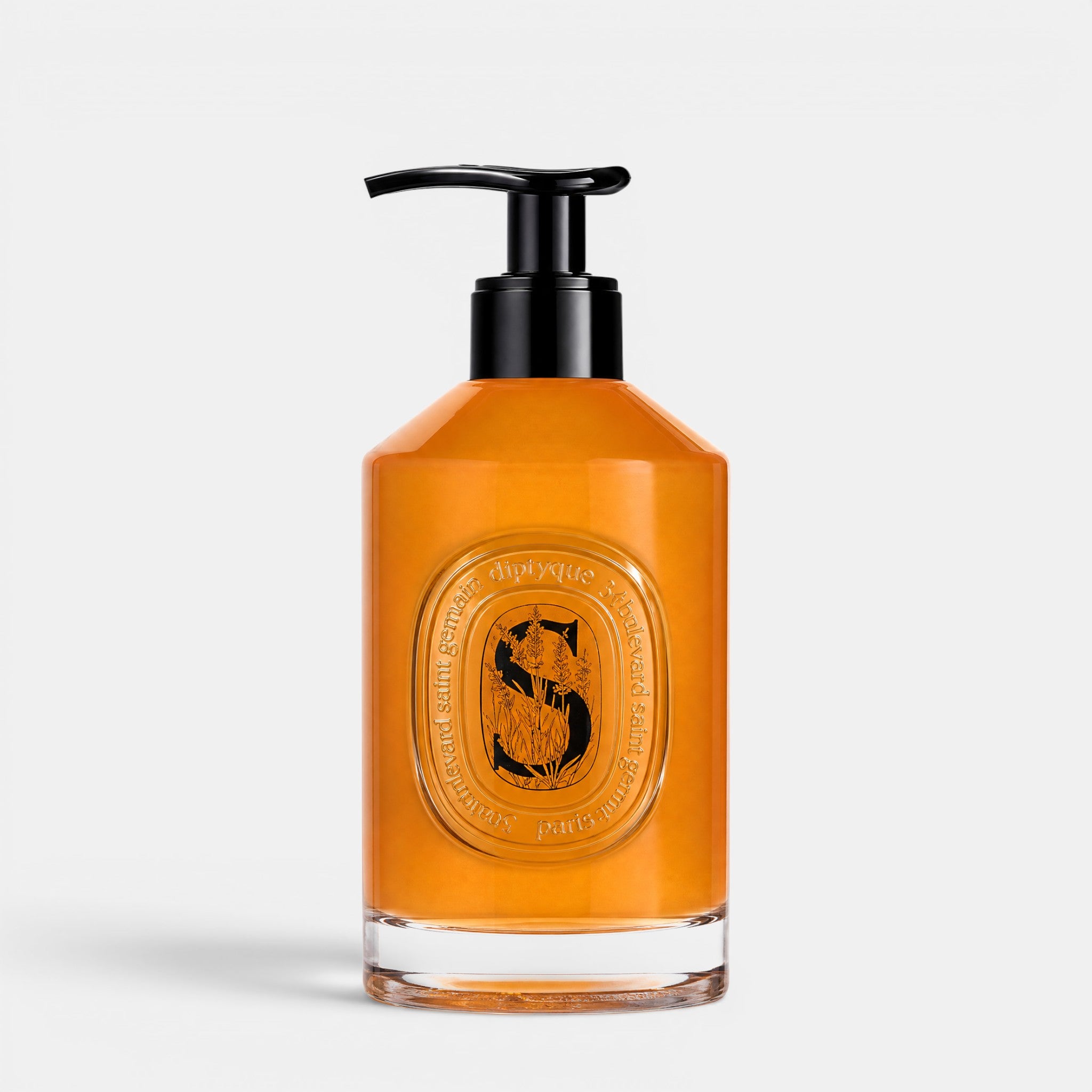 Shop Rescue Spa softening hand wash in a clear glass bottle with a black pump dispenser and amber liquid soap.