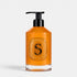 Shop Rescue Spa softening hand wash in a clear glass bottle with a black pump dispenser and amber liquid soap.