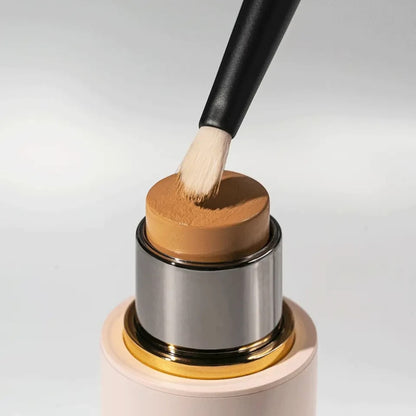 Shop Rescue Spa Spot Check Brush with soft nylon bristles applying foundation from a stick for targeted coverage.