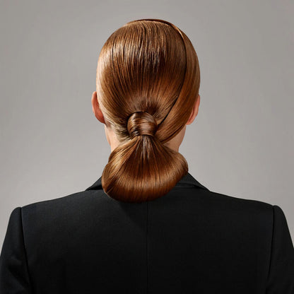 Shop Rescue Spa Superfine Strong Hair Spray on a model with auburn hair styled in a sleek, low bun with a knot detail.