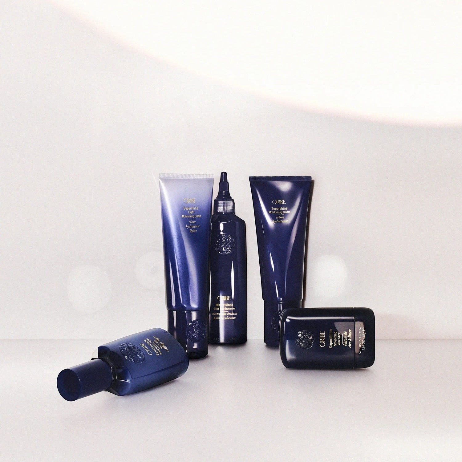 Shop Rescue Spa Oribe Supershine Light Moisturizing Cream in a blue tube, with other Oribe hair products.