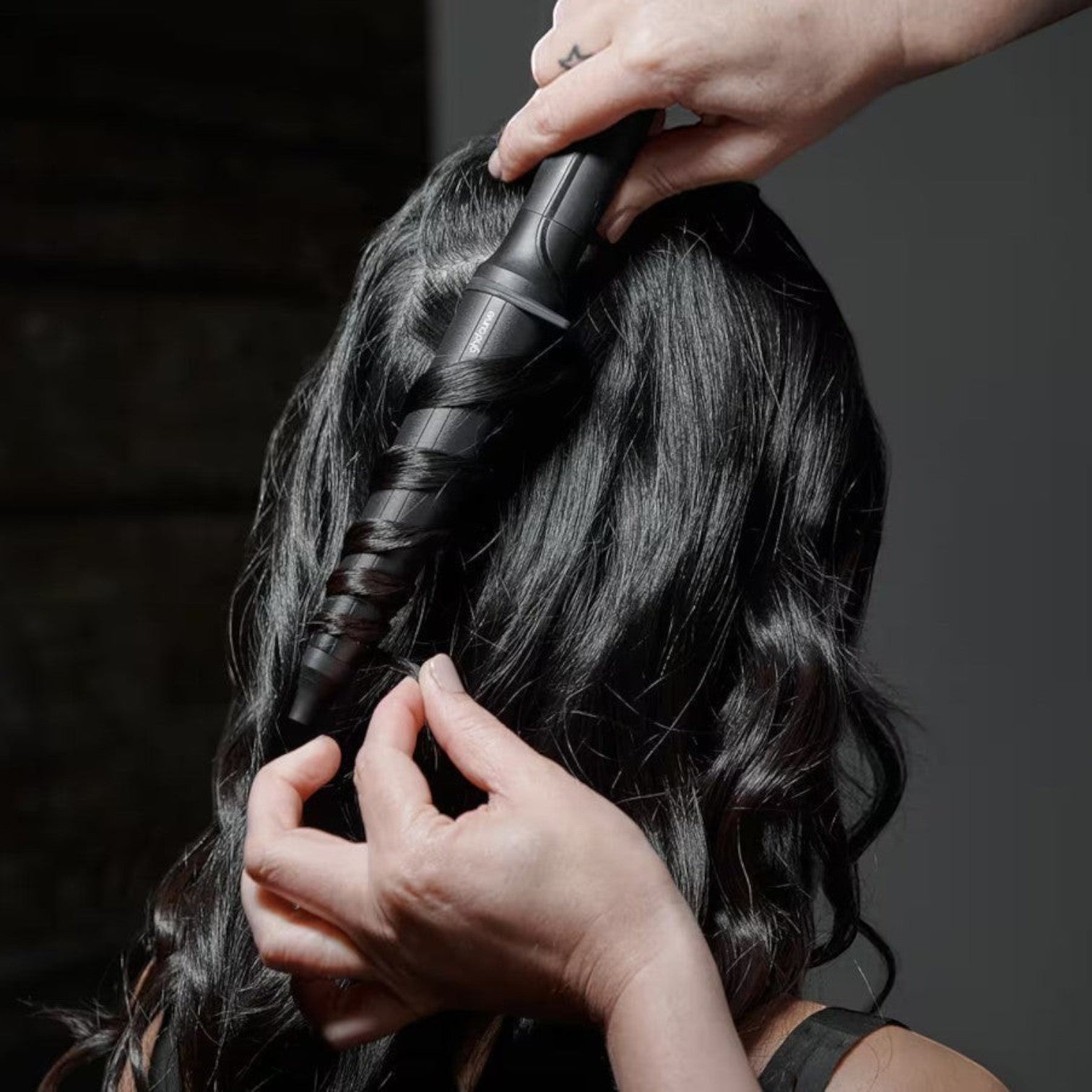 Shop Rescue Spa ghd Creative Curl tapered wand styling dark hair into textured beachy waves