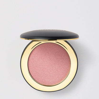 Shop Rescue Spa Super Loaded Tinted Highlight in a shimmering pink cream formula inside a sleek black and gold compact.