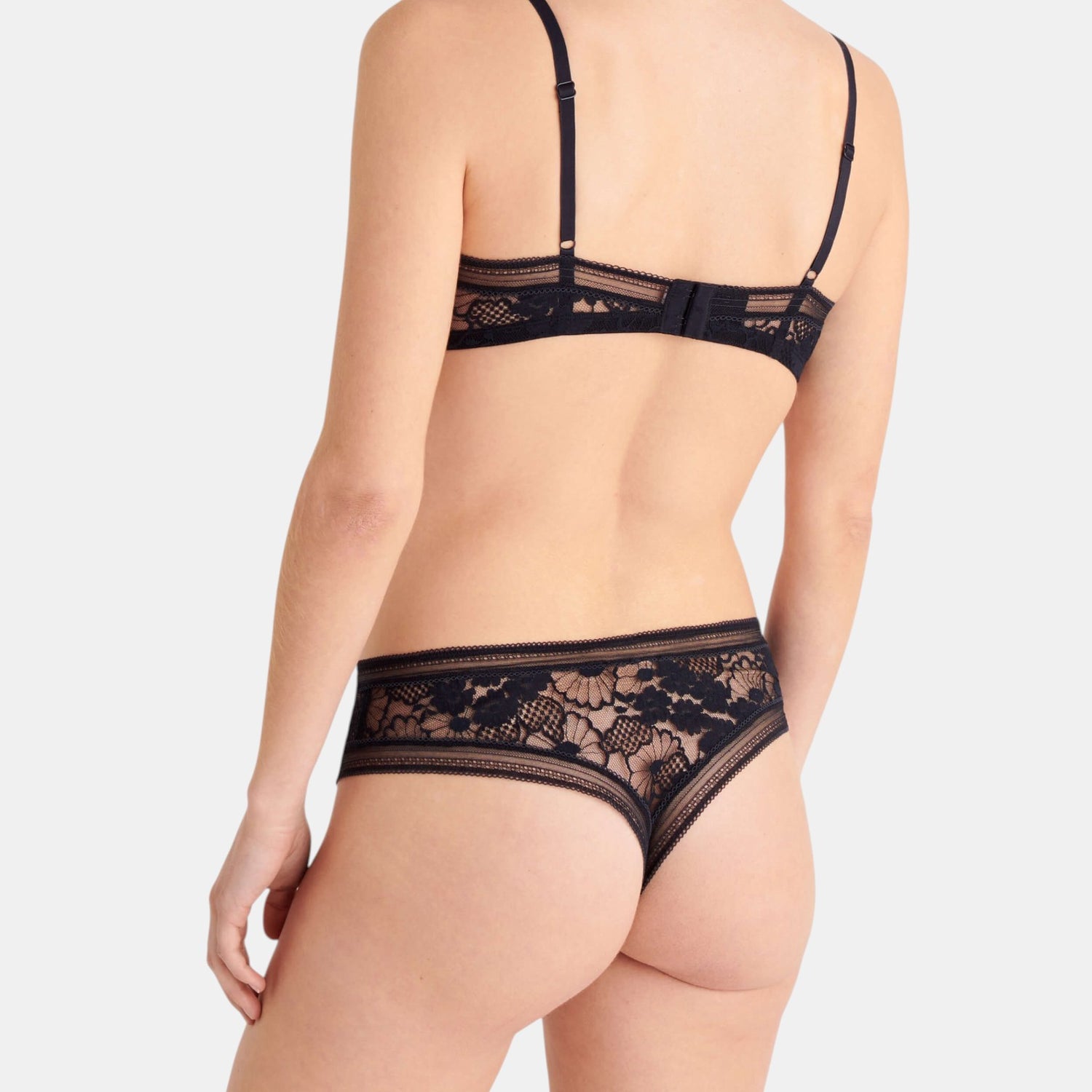 Shop Rescue Spa Tisane black lace thong with matching bra, featuring delicate floral embroidery and trim details.