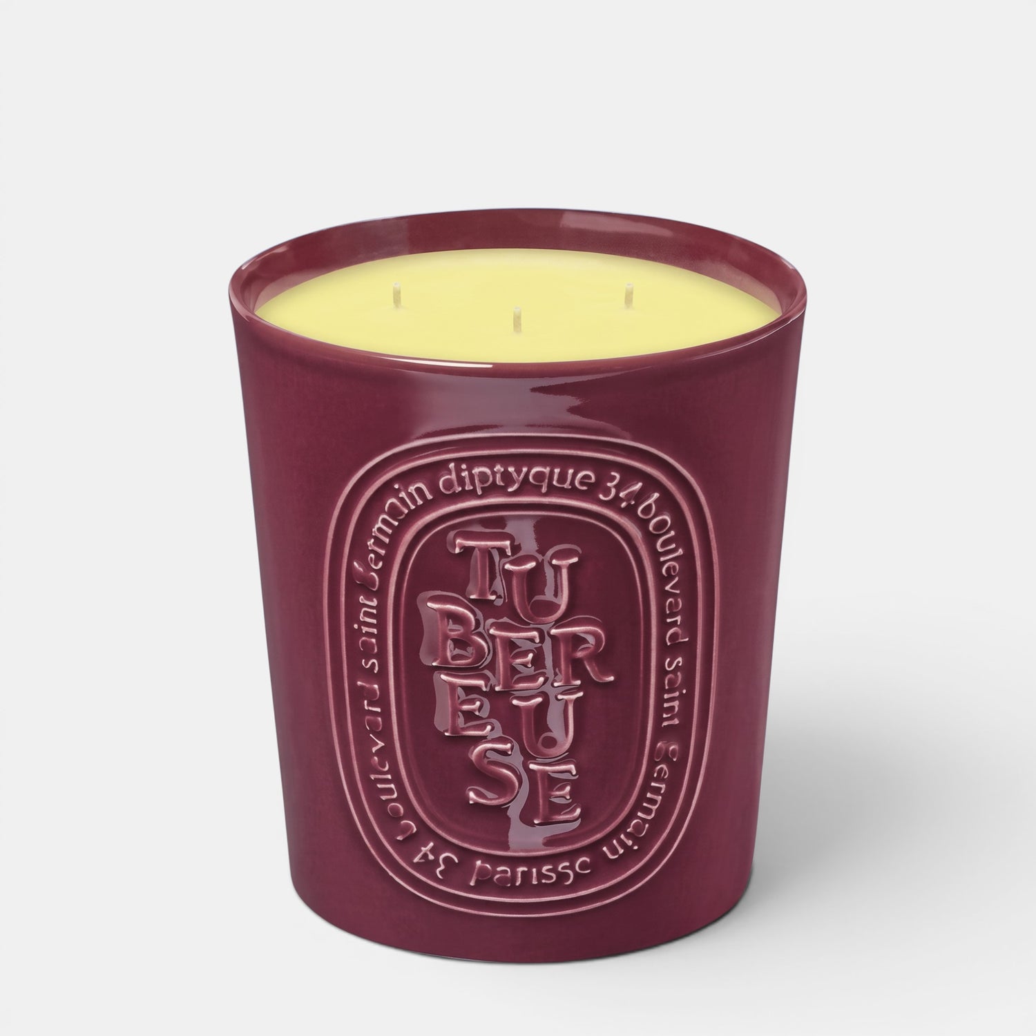 Shop Rescue Spa Tubereuse scented candle in a deep burgundy ceramic vessel with embossed lettering and yellow wax.