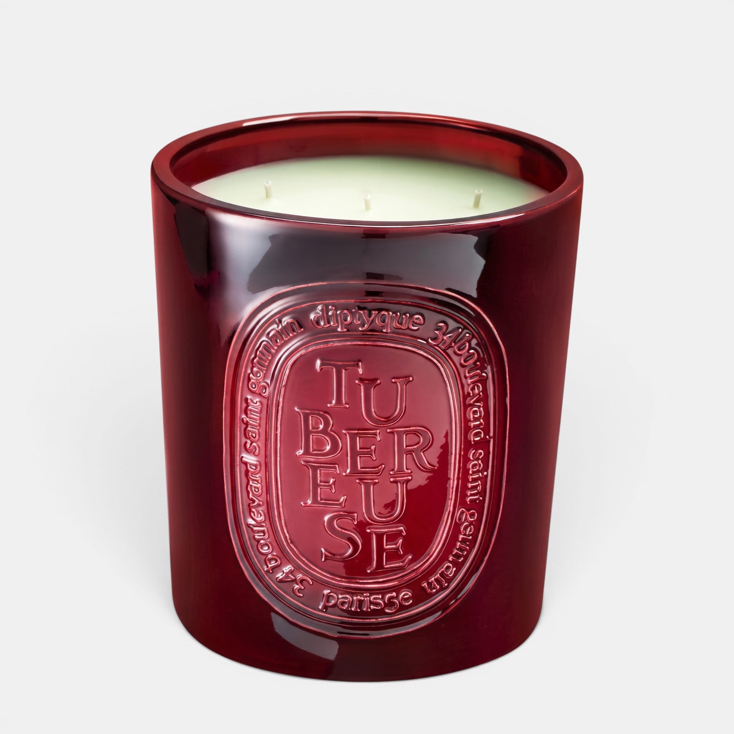 Shop Rescue Spa Tubereuse scented candle in a deep red glass jar with embossed branding and three wicks