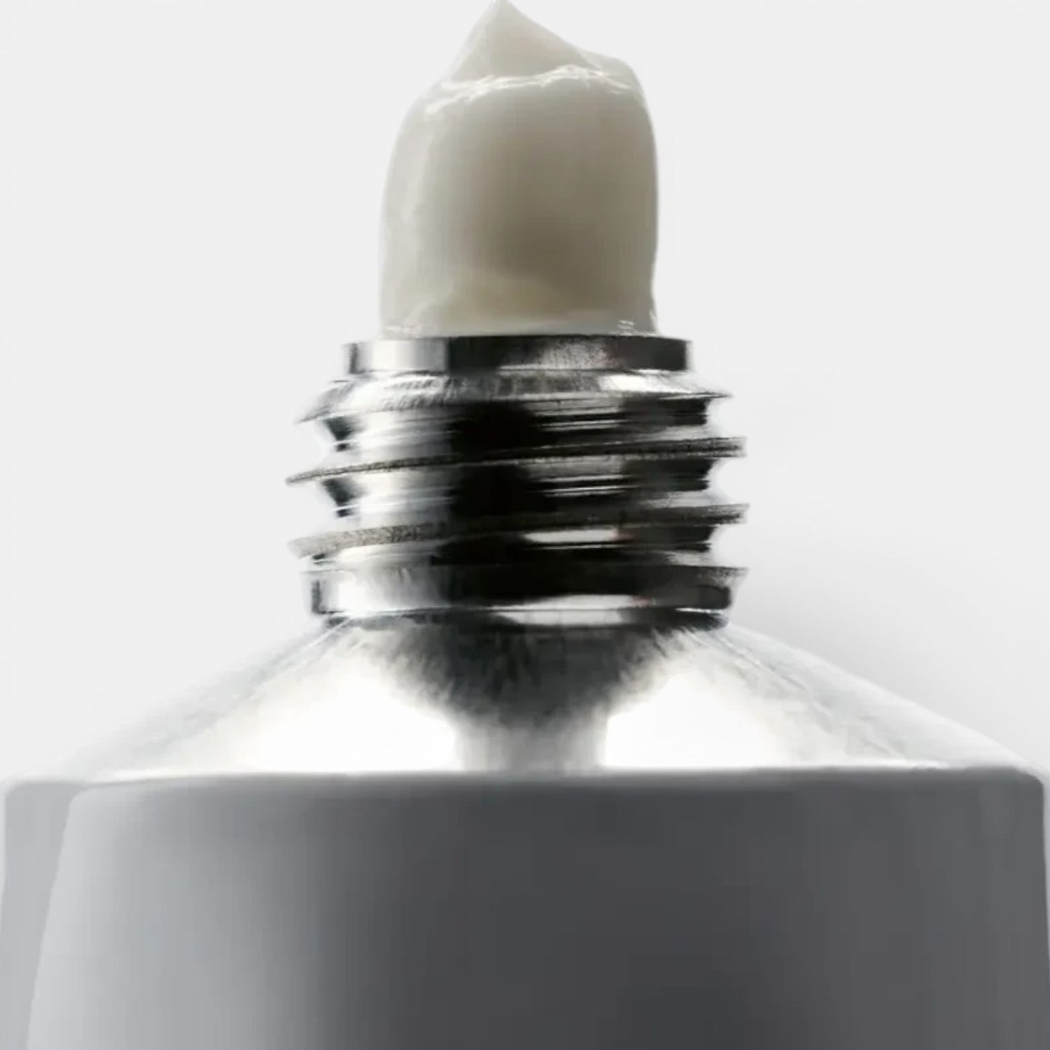 Shop Rescue Spa Tulipmania Hand and Nail Cream, white cream dispensed from a silver-capped tube.