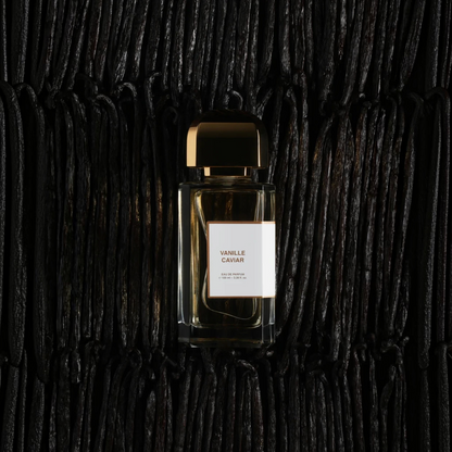 Shop Rescue Spa Vanille Caviar eau de parfum bottle resting on a bed of dark, textured vanilla beans.