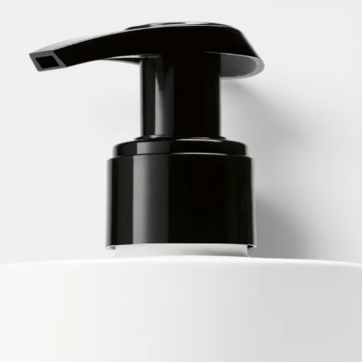 Shop Rescue Spa Vetyver Hand Lotion with black pump dispenser on white bottle. Notes of angelica, pomelo, mate, jasmine, violet, vetyver, cashmeran.
