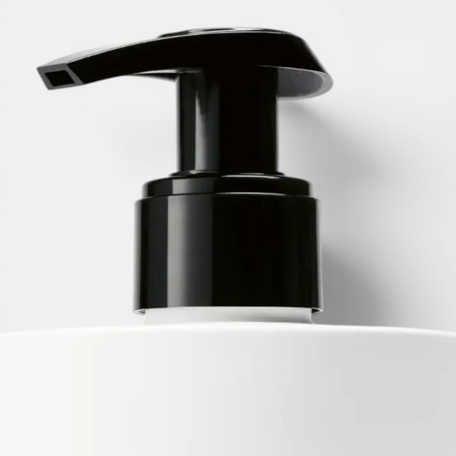 Shop Rescue Spa Vetyver Hand Lotion with black pump dispenser on white bottle. Notes of angelica, pomelo, mate, jasmine, violet, vetyver, cashmeran.
