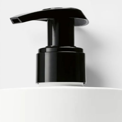 Shop Rescue Spa Vetyver Hand Lotion with black pump dispenser on white bottle. Notes of angelica, pomelo, mate, jasmine, violet, vetyver, cashmeran.