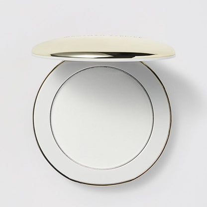 Shop Rescue Spa Vital Pressed Skincare translucent powder in a sleek, round gold-trimmed compact case.