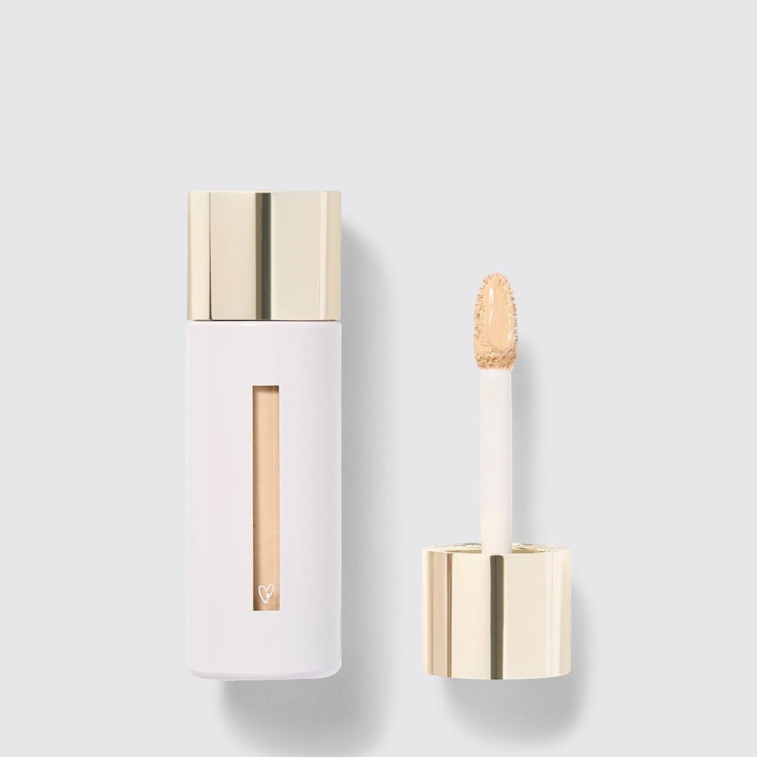 Shop Rescue Spa Westman Atelier Vital Skincare Concealer in a white bottle with a gold cap and doe-foot applicator.