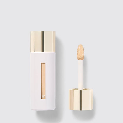 Shop Rescue Spa Westman Atelier Vital Skincare Concealer in a white bottle with a gold cap and doe-foot applicator.