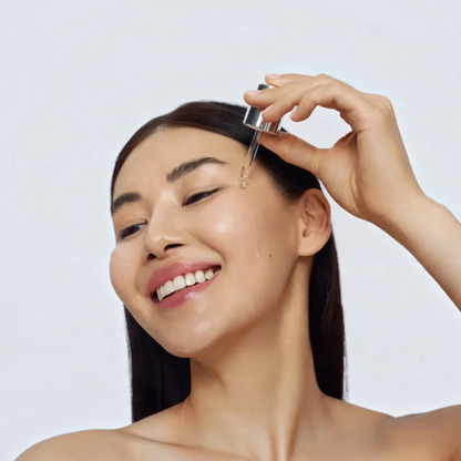 Shop Rescue Spa Black Diamond Vitamin C Brightening Booster serum being applied to a smiling woman&