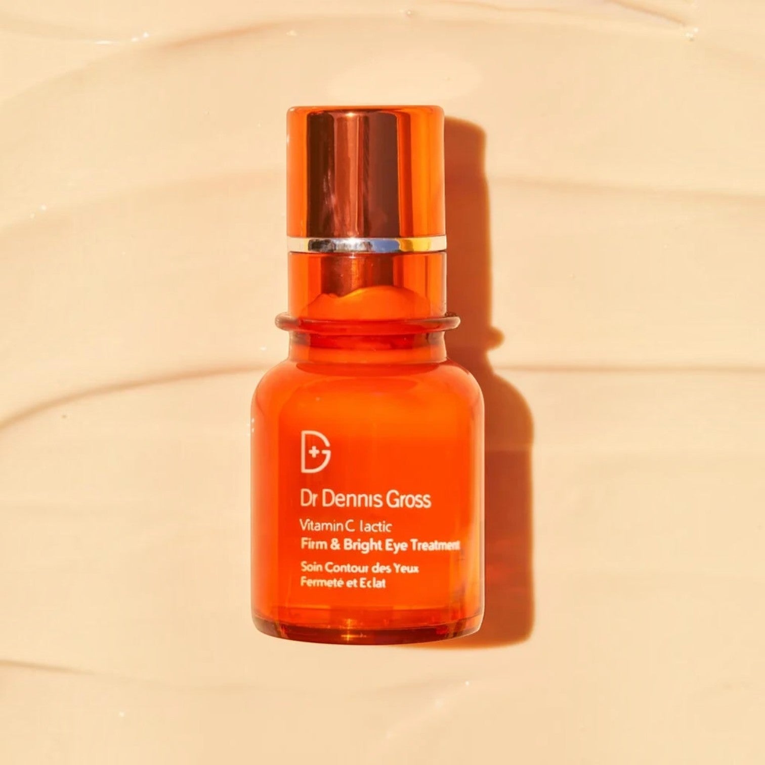 Shop Rescue Spa Dr Dennis Gross Vitamin C Lactic Firm &amp; Bright Eye Treatment in an orange glass pump bottle.