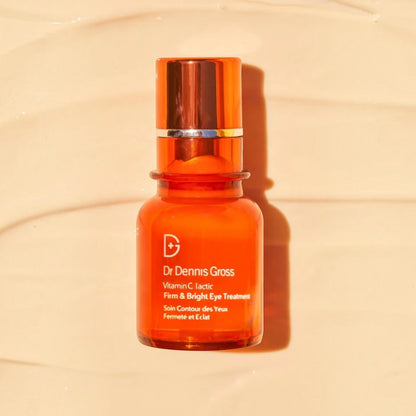 Shop Rescue Spa Dr Dennis Gross Vitamin C Lactic Firm &amp; Bright Eye Treatment in an orange glass pump bottle.