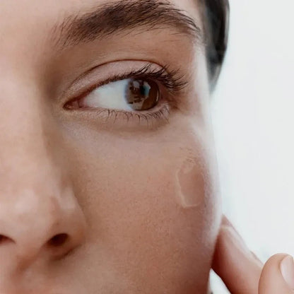 Shop Rescue Spa Vitamin C serum applied as a clear drop on a woman&