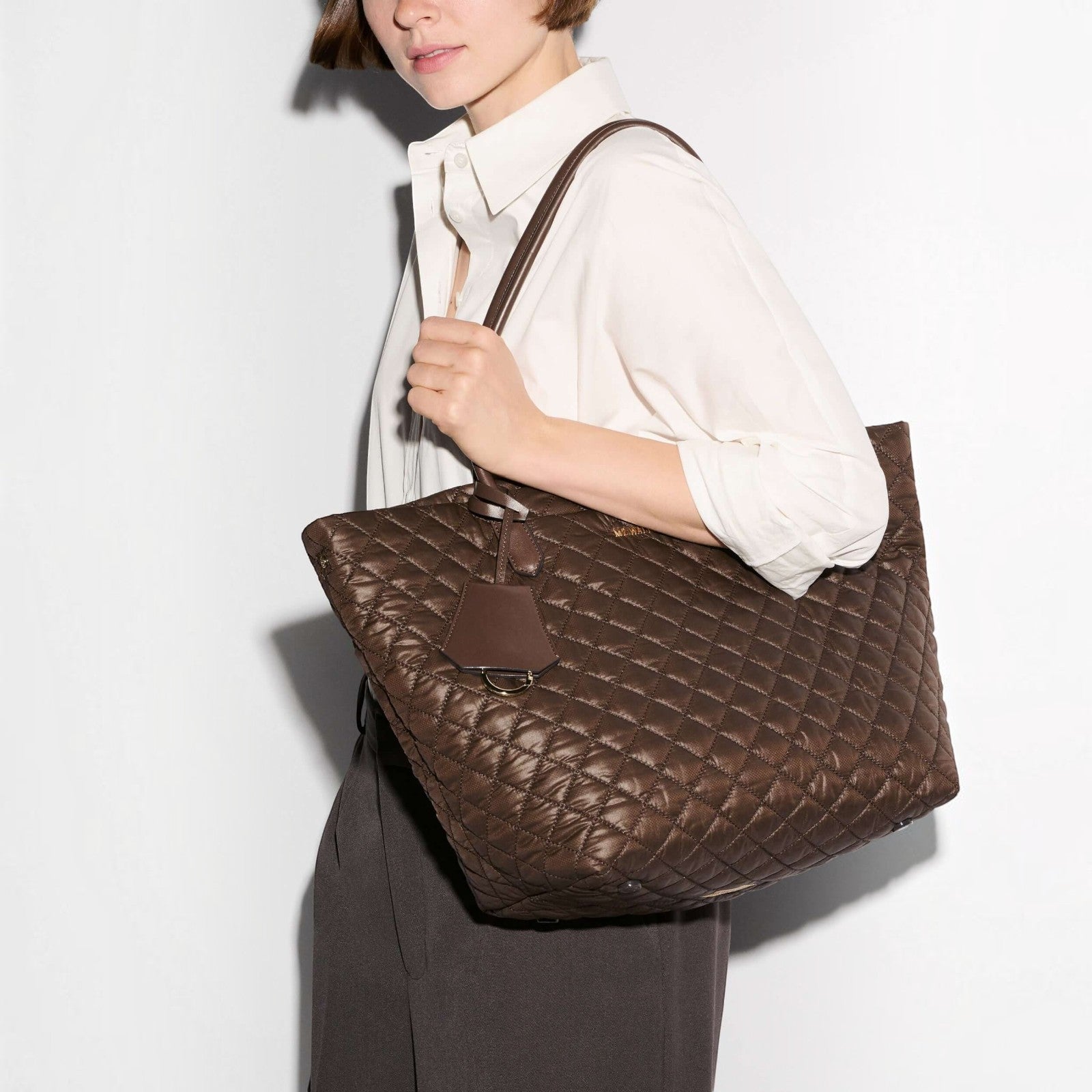Shop Rescue Spa walnut brown quilted nylon daily tote bag with Italian leather handles carried on a woman&