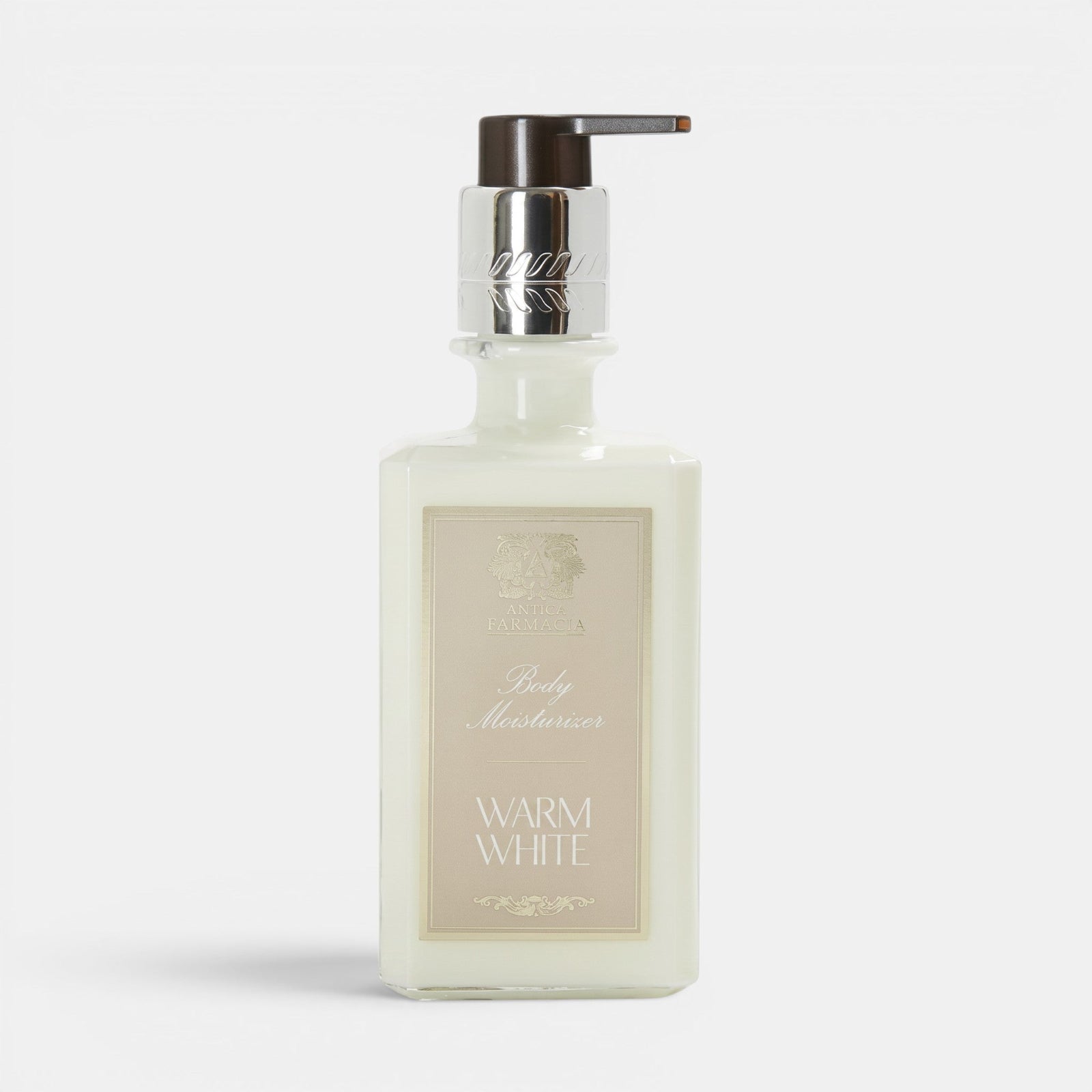 Shop Rescue Spa Warm White body moisturizer in a clear glass bottle with a silver pump dispenser