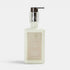 Shop Rescue Spa Warm White body moisturizer in a clear glass bottle with a silver pump dispenser