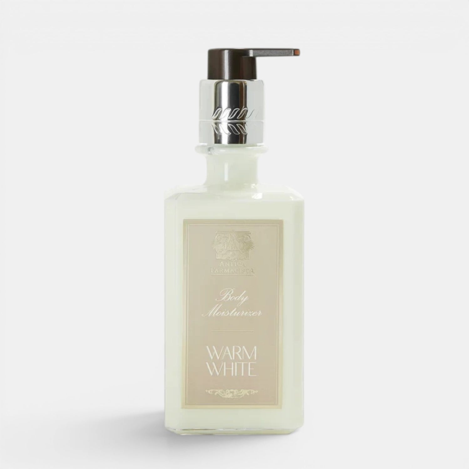 Shop Rescue Spa Warm White hand and body moisturizer in a square glass bottle with a silver pump dispenser.