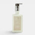 Shop Rescue Spa Warm White hand and body moisturizer in a square glass bottle with a silver pump dispenser.