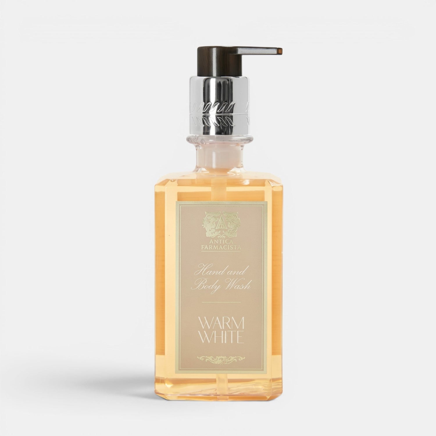 Shop Rescue Spa Warm White hand and body wash in a clear rectangular bottle with a silver pump dispenser.