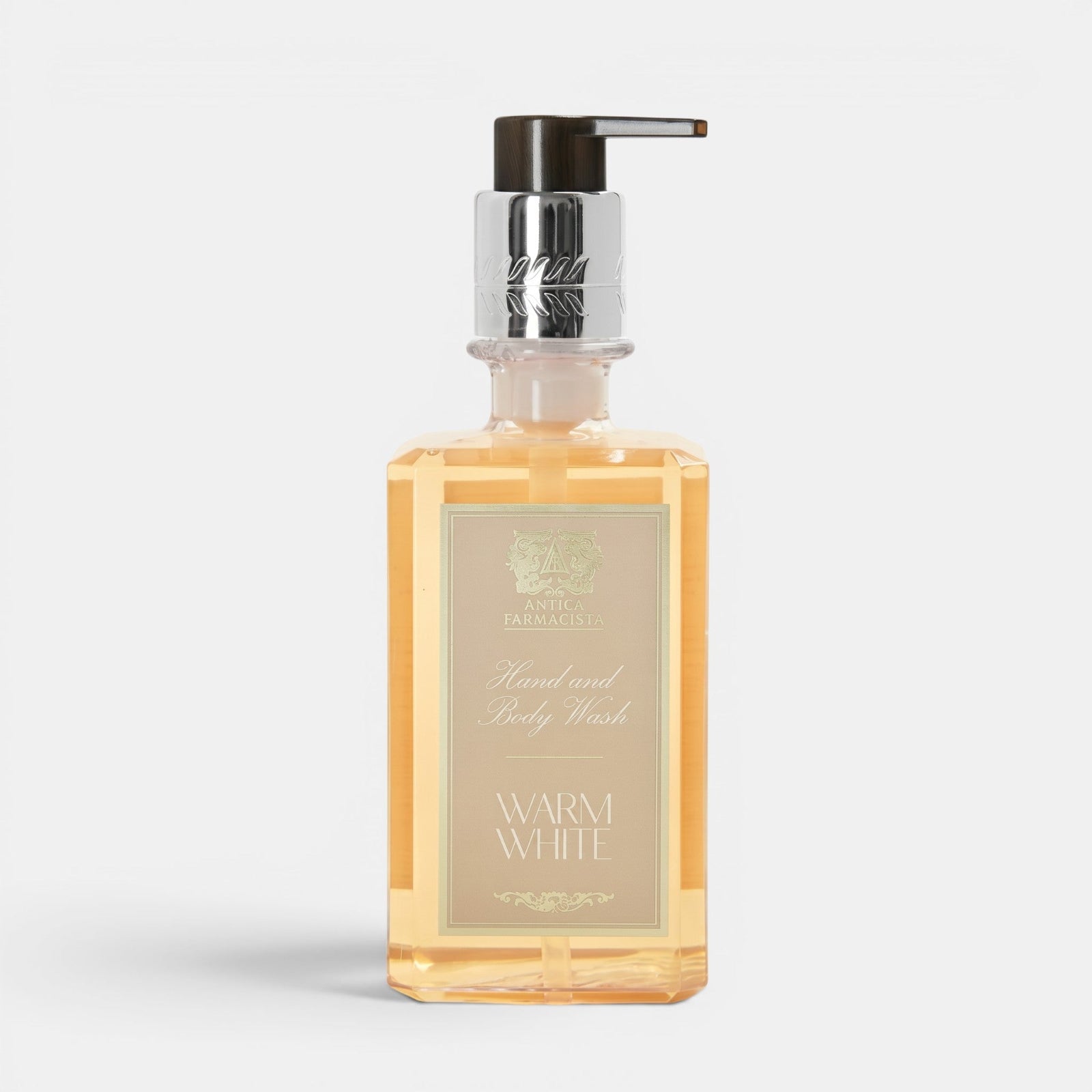 Shop Rescue Spa Warm White hand and body wash in a clear rectangular bottle with a silver pump dispenser.