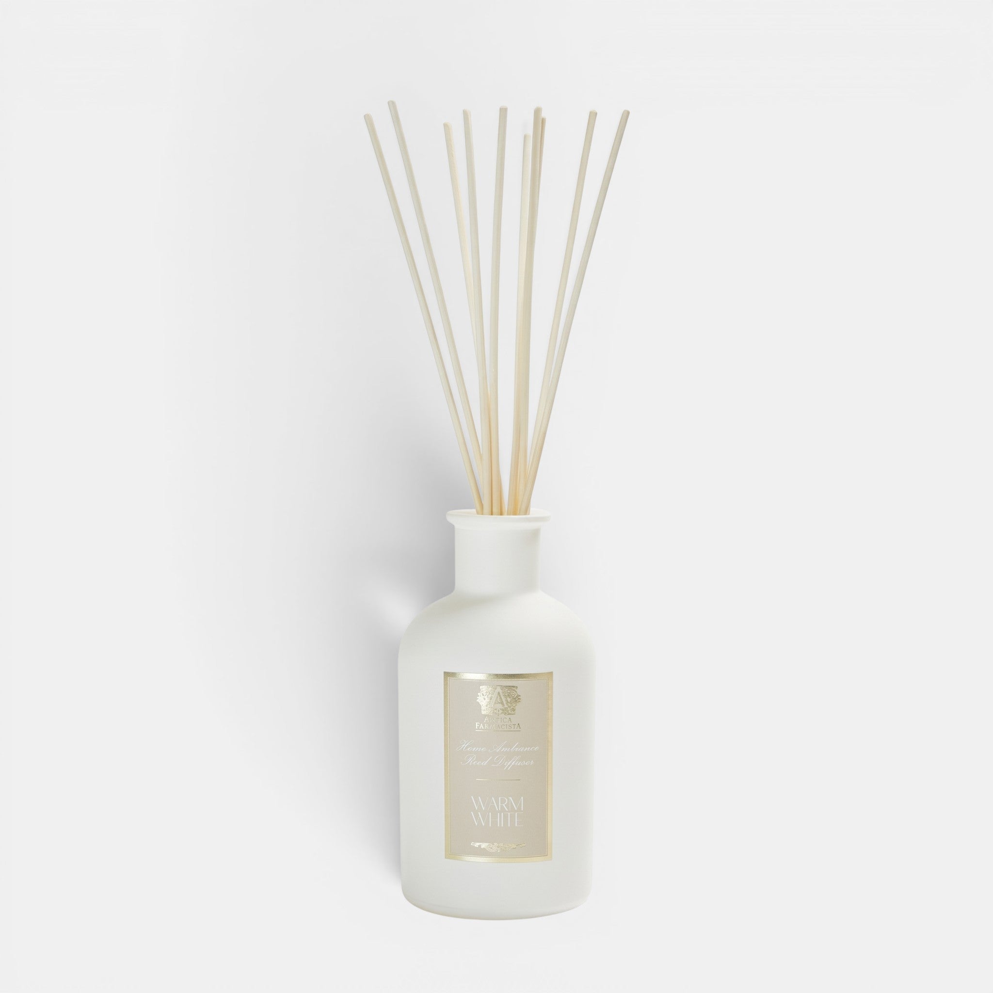Shop Rescue Spa Antica Warm White reed diffuser in a frosted white apothecary vessel with natural rattan reeds.