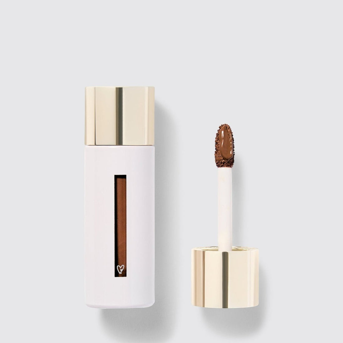 Shop Rescue Spa Westman Atelier Vital Skincare Concealer in a white bottle with a gold cap and doe-foot applicator