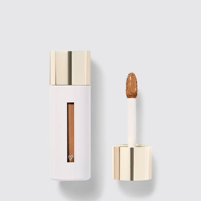Shop Rescue Spa Westman Atelier Vital Skincare Concealer in a white bottle with a gold cap and doe-foot applicator.