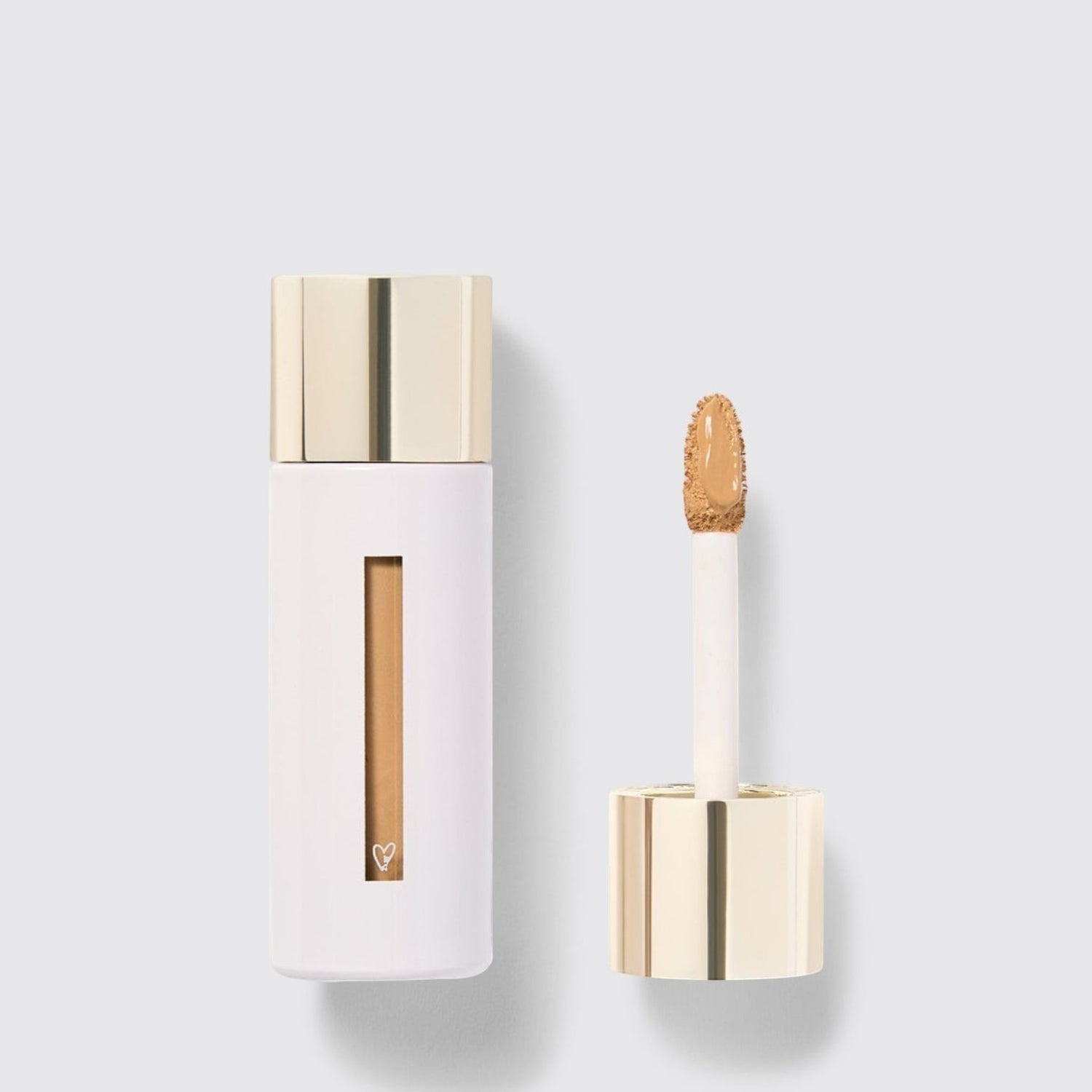 Shop Rescue Spa Westman Atelier Vital Skincare Concealer in a white bottle with a gold cap and doe-foot applicator