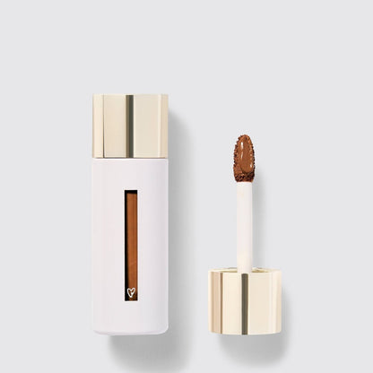 Shop Rescue Spa Westman Atelier Vital Skincare Concealer in a white bottle with a gold cap and doe-foot applicator