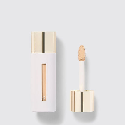 Shop Rescue Spa Westman Atelier Vital Skincare Concealer in a white bottle with a gold cap and doe-foot applicator.