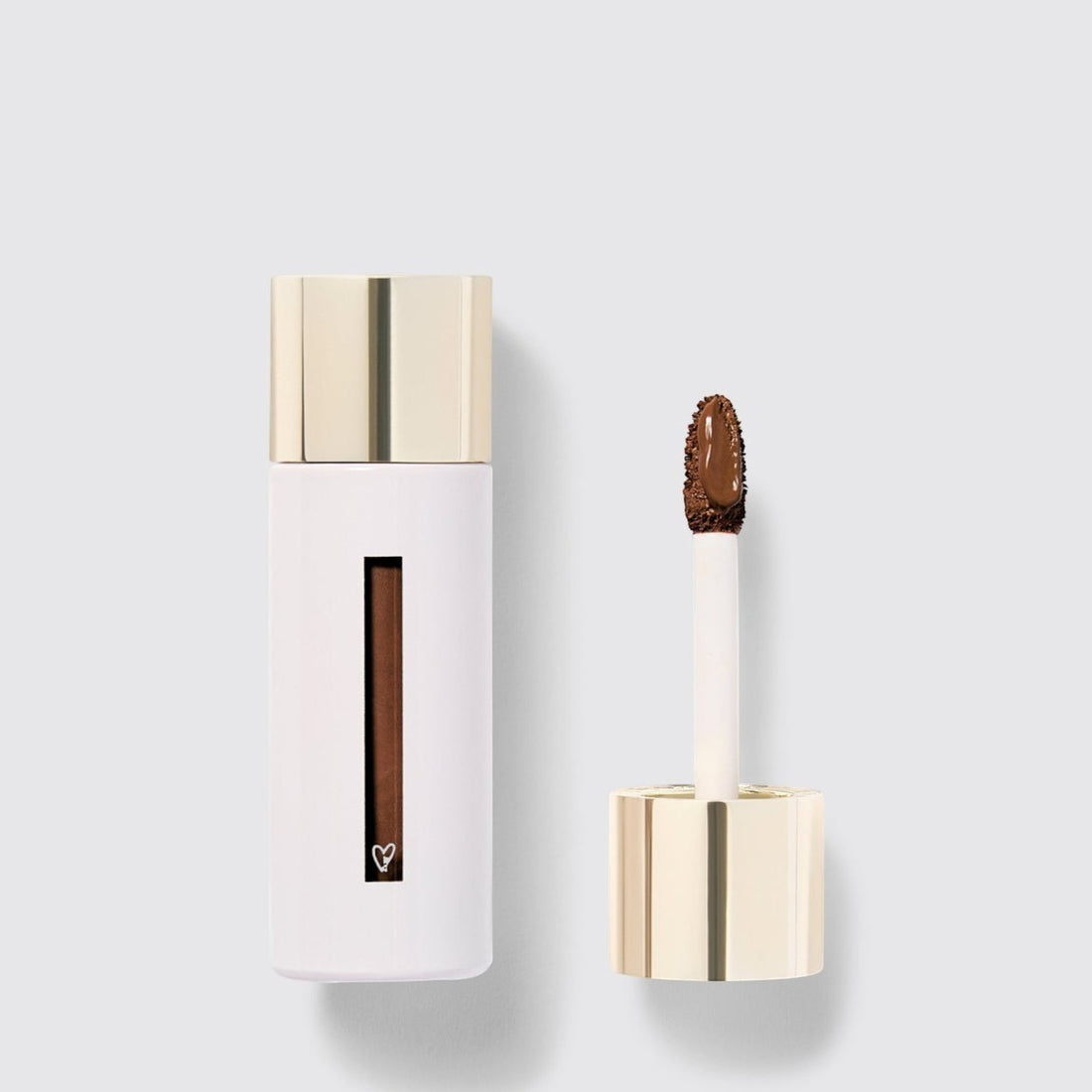 Shop Rescue Spa Westman Atelier Vital Skincare Concealer in a white bottle with a gold cap and doe-foot applicator.