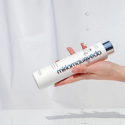 Shop Rescue Spa Glacial White Caviar Hydra-Pure Rescue Masque in a white bottle held by a hand with water droplets