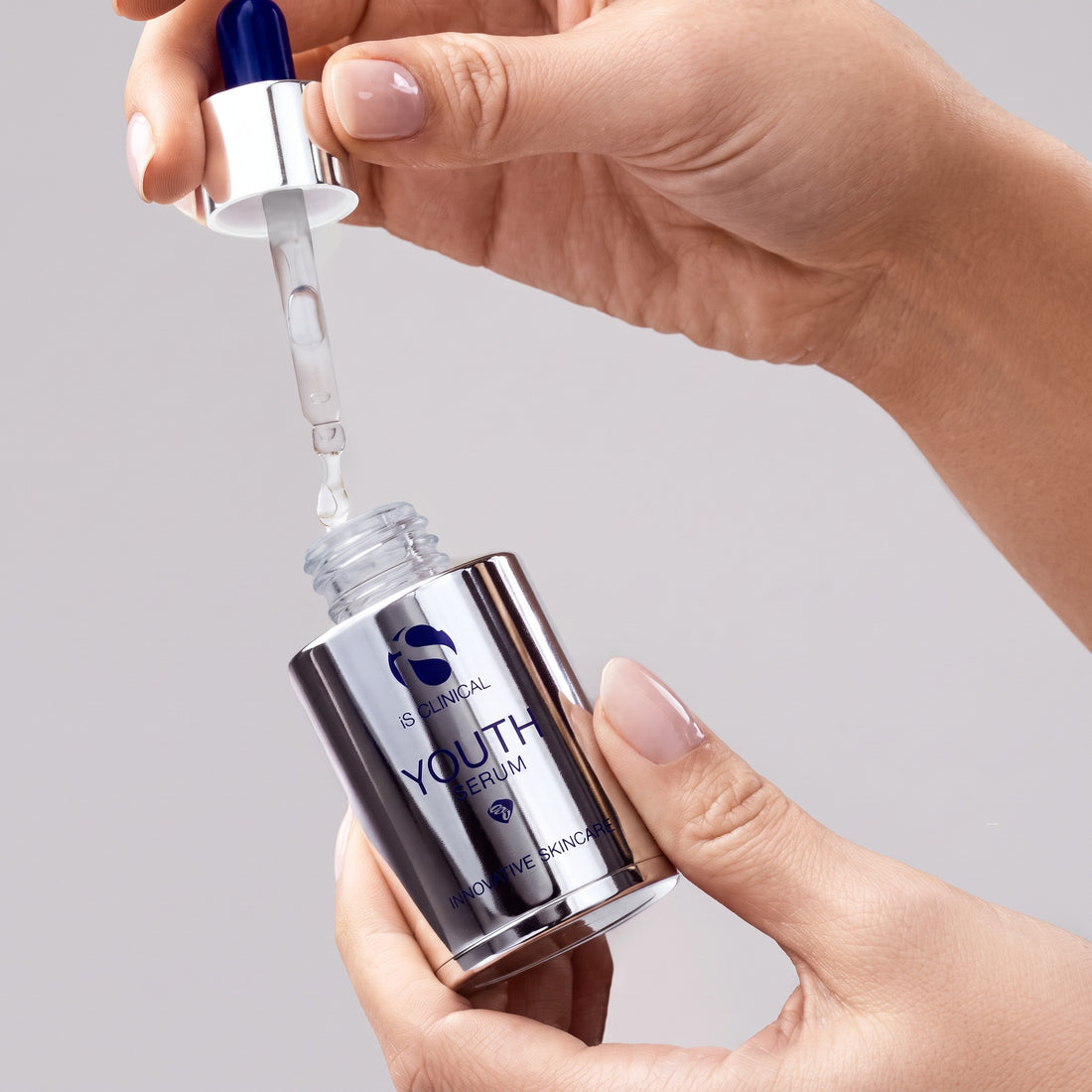 Shop Rescue Spa iS Clinical Youth Serum bottle with dropper dispensing clear anti-aging facial treatment