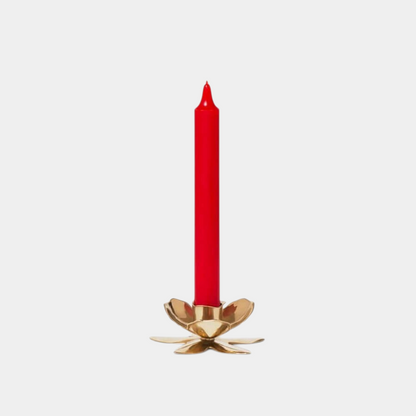 Shop Rescue Spa gold plated flower shaped candlestick holding a slim red taper candle on a plain background