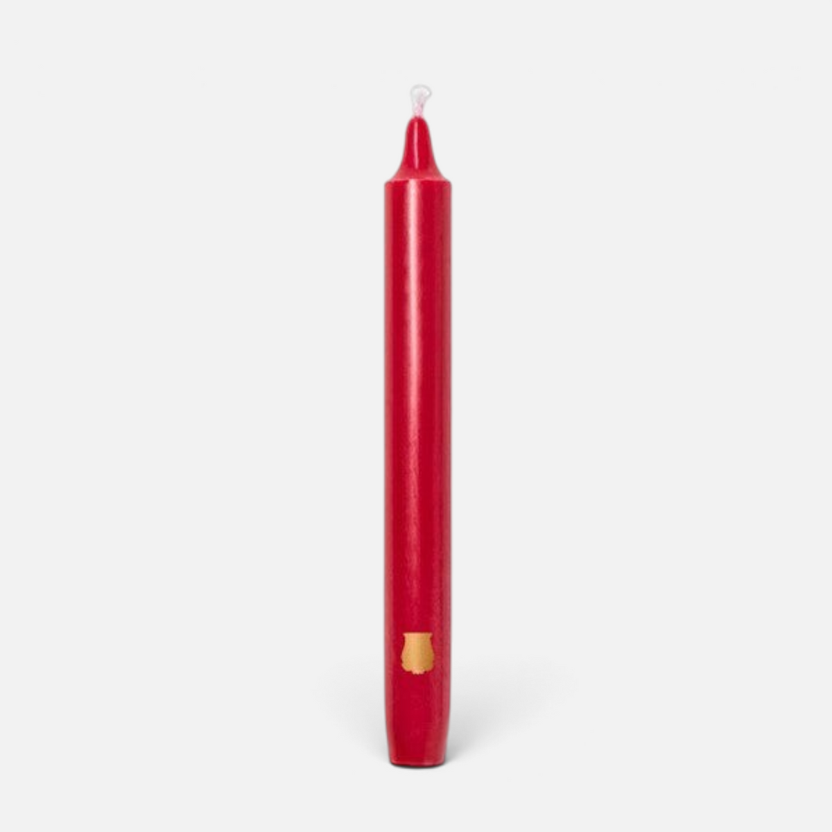 Shop Rescue Spa Madeleine taper candle in red wax with a small gold emblem detail on a plain background