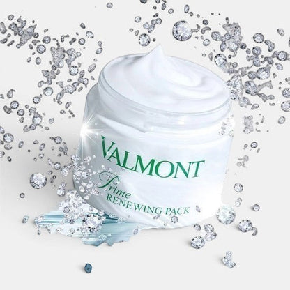 Open Valmont Prime Renewing Pack jar with visible cream inside, surrounded by small diamonds on a styled surface.