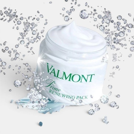 Open Valmont Prime Renewing Pack jar with visible cream inside, surrounded by small diamonds on a styled surface.